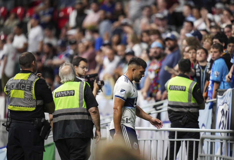 Vancouver Whitecaps' Lucas Cavallini, center, leaves the field after receiving a red card during second-half MLS soccer match action in Vancouver, British Columbia, Saturday, Aug. 27, 2022. (Darryl Dyck/The Canadian Press via AP)