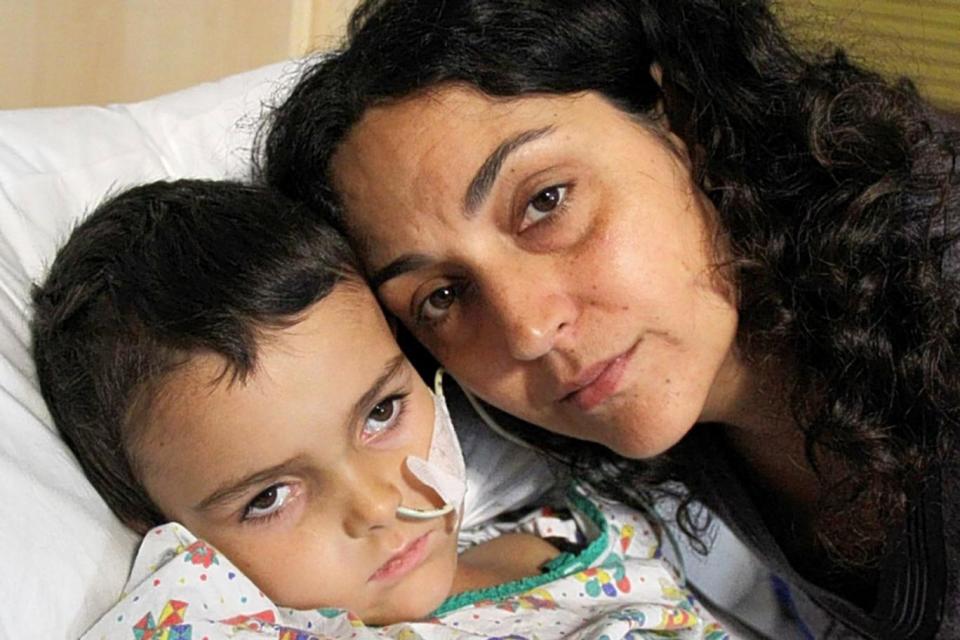 Re-united: Ashya King in hospital with his mother Naghemeh before her arrest (Facebook)