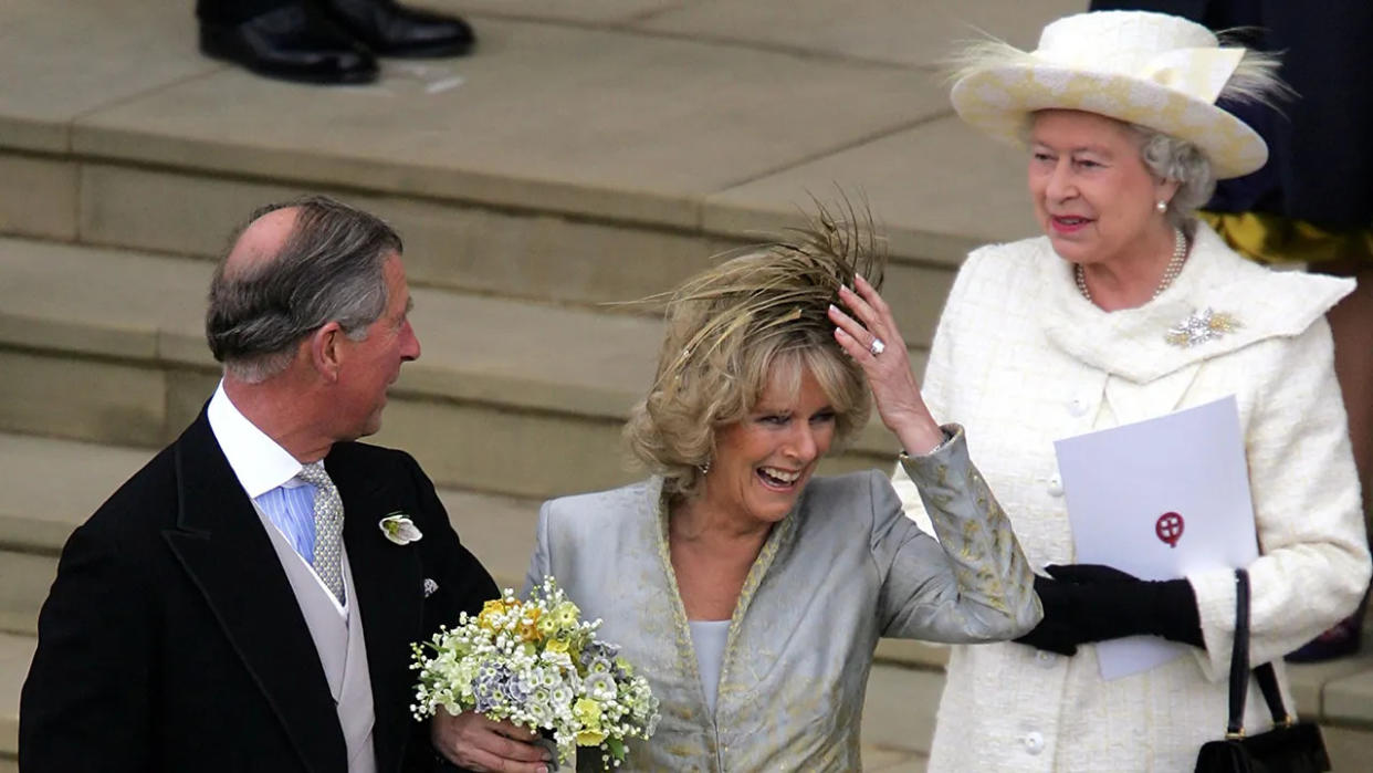 Camilla smiling on her wedding day in between Prince Charles and Queen Elizabeth II