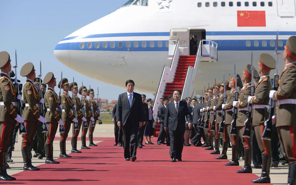 Senior Chinese official Li Zhanshu, center let, walks with Choe Ryong Hae, center right, vice-chairman of the Central Committee of North Korea's ruling Workers' Party, upon his arrival at Pyongyang International Airport in Pyongyang, North Korea, Saturday, Sept. 8, 2018. Li, the Chinese ruling party's third highest official, will attend a big military parade on the 70th anniversary of North Korea's founding on Sunday, Sept. 9. (Kyodo News via AP)