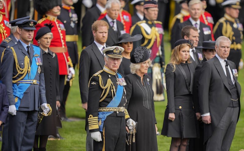 Prince Andrew, from right, Princess Beatrice, Camilla, Britain’s King Charles III, Meghan, Duchess of Sussex, Prince Harry and Prince William watch as the coffin of Queen Elizabeth II is placed into the hearse following the state funeral service in Westminster Abbey.