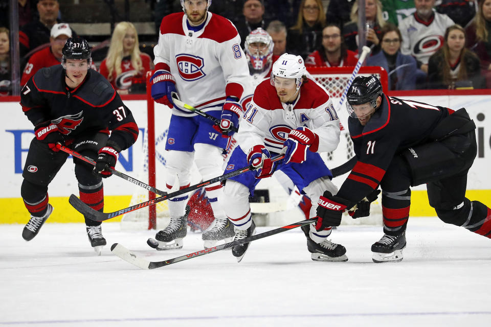 Carolina Hurricanes' Jordan Staal (11) battles with Montreal Canadiens' Brendan Gallagher (11) as Carolina Hurricanes' Andrei Svechnikov (37), of Russia, looks on during the first period of an NHL hockey game in Raleigh, N.C., Tuesday, Dec. 31, 2019. (AP Photo/Karl B DeBlaker)