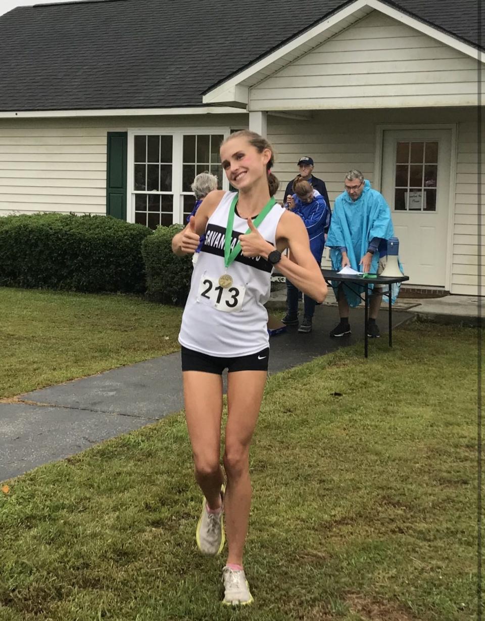 Savannah Arts junior Leah Nyce poses with the gold medal she won at the 7th Mile Farm Invitational on Oct. 12, 2023.