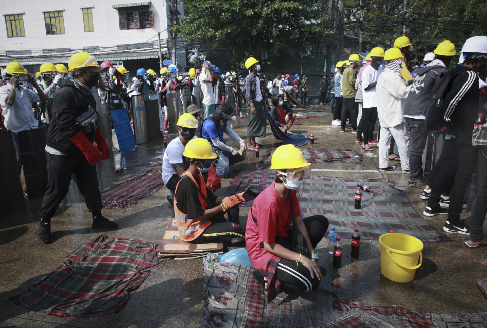 Anti-coup protesters with helmet and wet cloths ready to put off tear gas gather during a demonstration in Yangon, Myanmar, Saturday, March 6, 2021. Security forces in Myanmar again used force Saturday to disperse anti-coup protesters, a day after the U.N. special envoy urged the Security Council to take action to quell junta violence that this week left about 50 peaceful demonstrators dead and scores injured. (AP Photo)