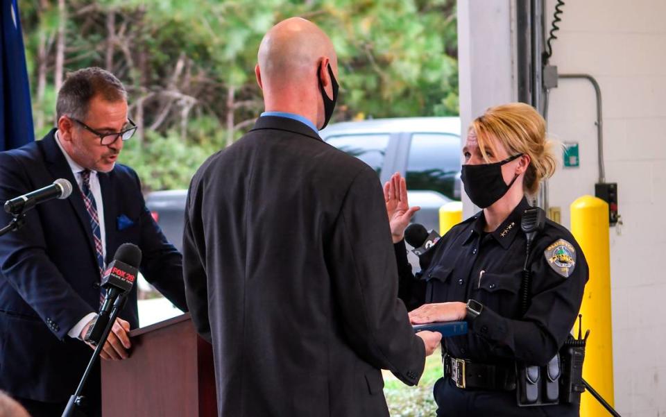 Marc Orlando, left, Bluffton’s town manager reads the oath of office on Monday, Oct. 12, 2020 as Stephenie Price, right, assumes the responsibilities of the town’s chief of police.