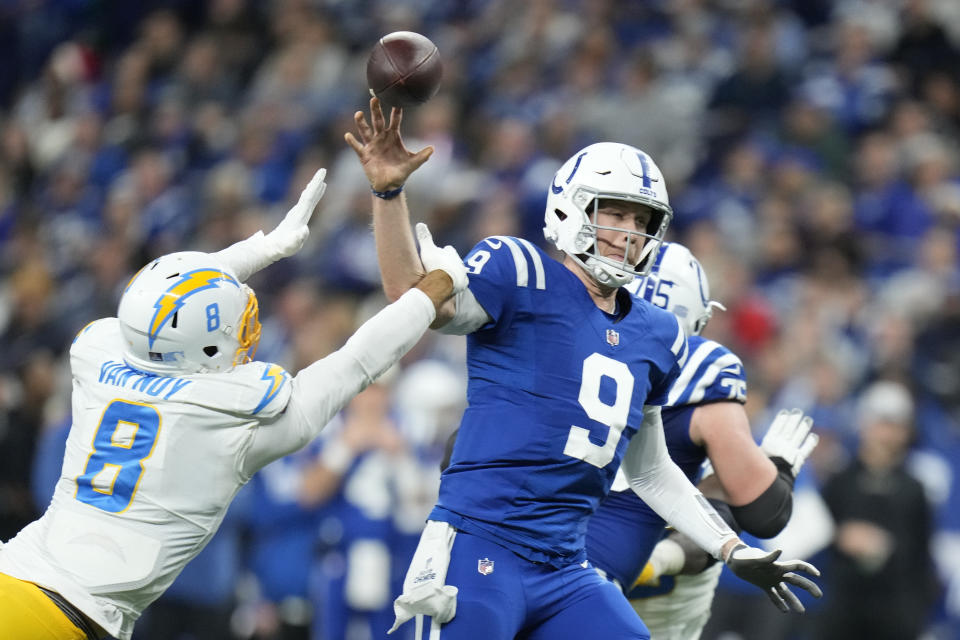 Indianapolis Colts quarterback Nick Foles throws as he is hit by Los Angeles Chargers' Kyle Van Noy (8) during the second half of an NFL football game, Monday, Dec. 26, 2022, in Indianapolis. (AP Photo/Michael Conroy)