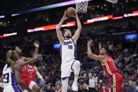 Sacramento Kings forward Domantas Sabonis (10) goes to the basket over New Orleans Pelicans guard CJ McCollum (3) in the first half of an NBA basketball play-in tournament game in New Orleans, Friday, April 19, 2024. (AP Photo/Gerald Herbert)