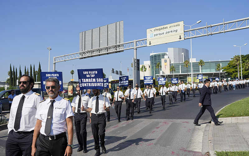 AP Air Portugal pilots walk during a protest march