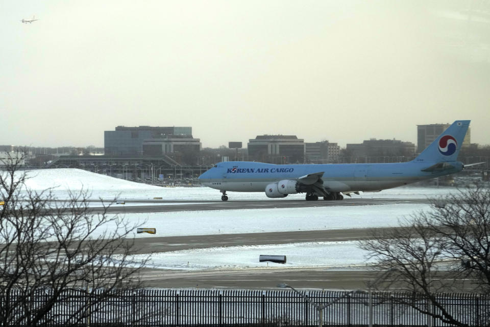 A Korean Air Cargo plane arrives at the O'Hare International Airport in Chicago, Sunday, Jan. 14, 2024. Wind chill warning is in effect as dangerous cold conditions continue in the Chicago area. (AP Photo/Nam Y. Huh)