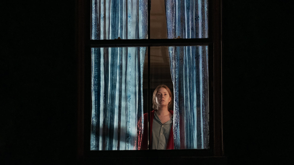 Amy Adams glares out a window in The Woman in the Window.