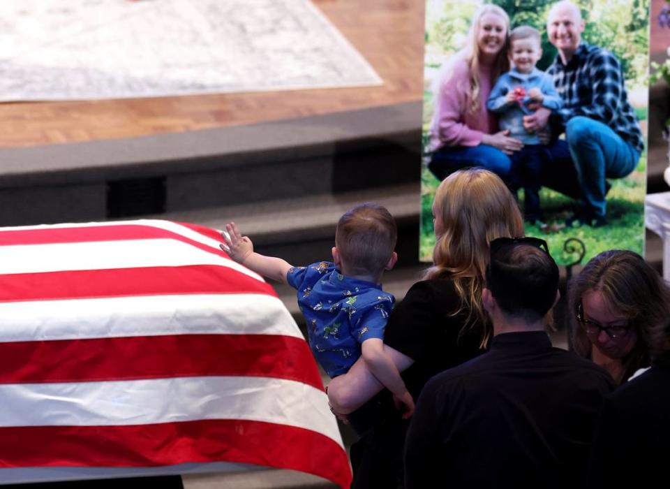 Andrew Eyer, 3 yrs., waves to his father Joshua Eyer casket during his funeral at First Baptist Church in Charlotte, NC on Friday, May 3, 2024. Mourners gathered at First Baptist Church to honor slain Charlotte-Mecklenburg Police Officer Joshua Eyer who died from wounds sustained during a standoff with a gunman on Monday, April 29th. Three other law enforcement officers were also killed in the shootout.