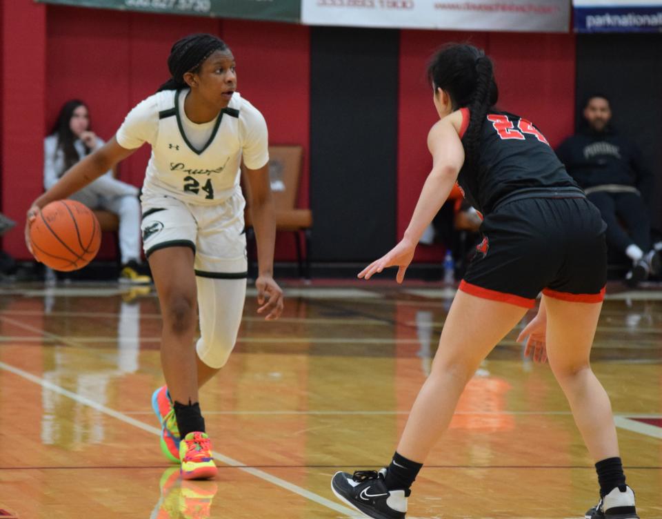 Tristan Williams brings the ball up the court against Bolingbrook Raiders.