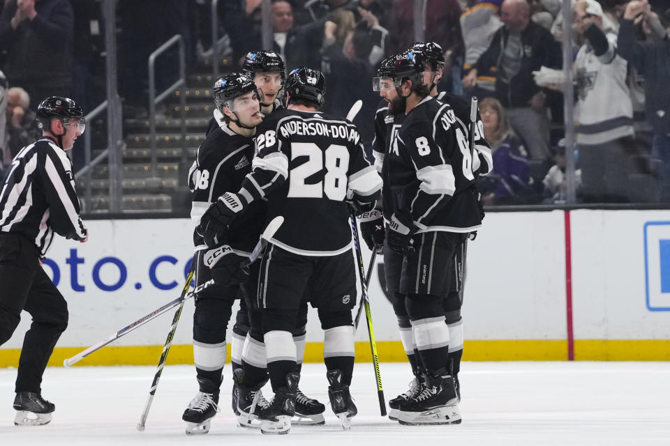 Los Angeles Kings right wing Alex Laferriere, left, is surrounded by teammates after scoring during the first period of an NHL hockey game against the New Jersey Devils, Sunday, March 3, 2024, in Los Angeles. (AP Photo/Ryan Sun)