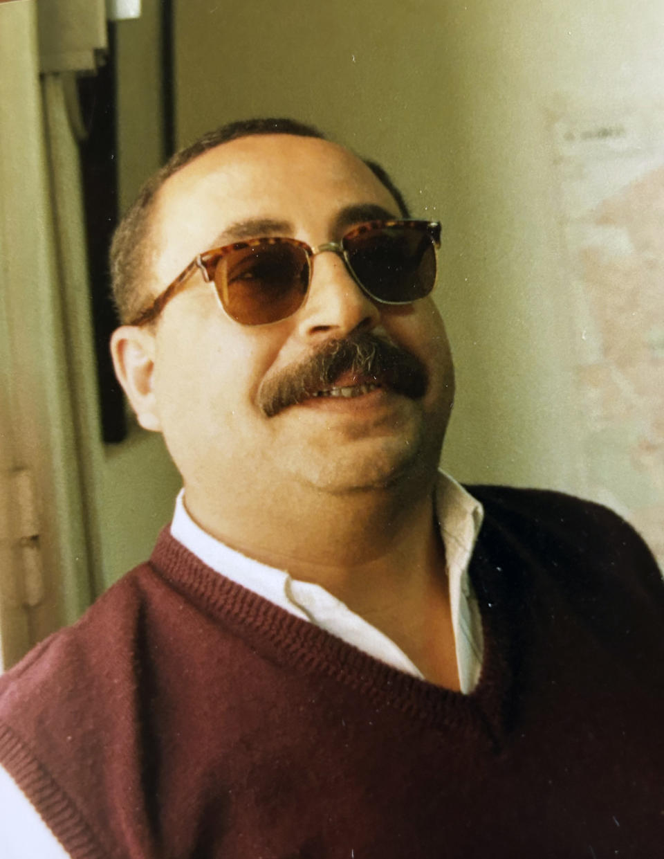 Moustafa Bassiouni stands for a portrait at the AP office in Cairo in 1997. Bassiouni, an intrepid photo assistant and driver for The Associated Press’ Cairo bureau, has died at age 64. His family said he died in a Cairo hospital on Saturday, June 10, 2023, after experiencing a heart attack. (AP Photo/Enric Marti)