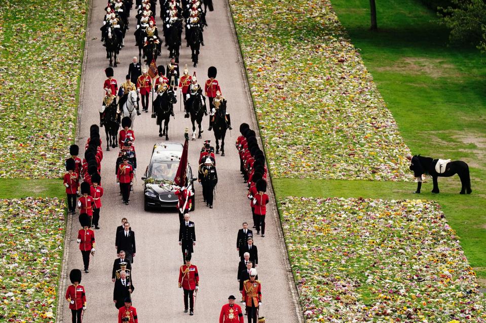 Emma, the monarch's fell pony, right, stands as the coffin of Queen Elizabeth II arrives at Windsor Castle for the committal service at St George's Chapel.