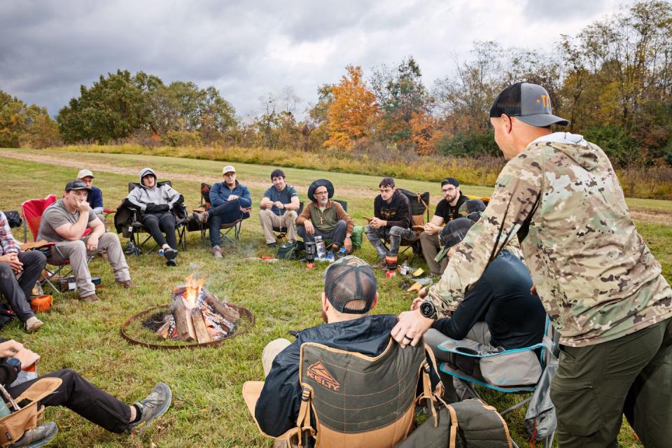 the authors man camp group gets acquainted around a fire on friday