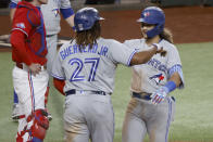 Toronto Blue Jays' Vladimir Guerrero Jr. (27) congratulates Bo Bichette, right, after Bichette's two-run home run against the Texas Rangers during the third inning of a baseball game Friday, Sept. 9, 2022, in Arlington, Texas. (AP Photo/Michael Ainsworth)