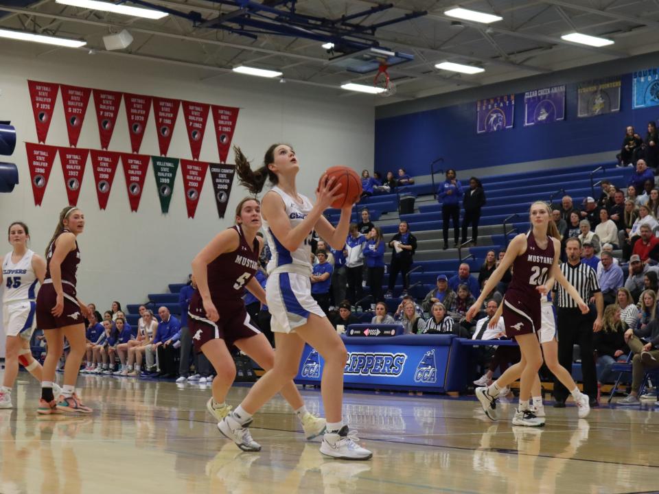 Clear Creek Amana freshman guard Averie Lower driving to the basket to attempt a layup.