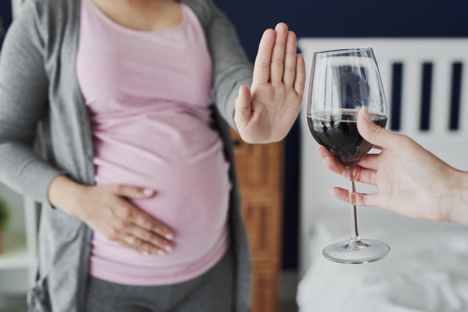 Pregnant woman refusing a glass of wine. It's best to avoid alcohol when pregnant, but there are other foods to limit too. (Getty)