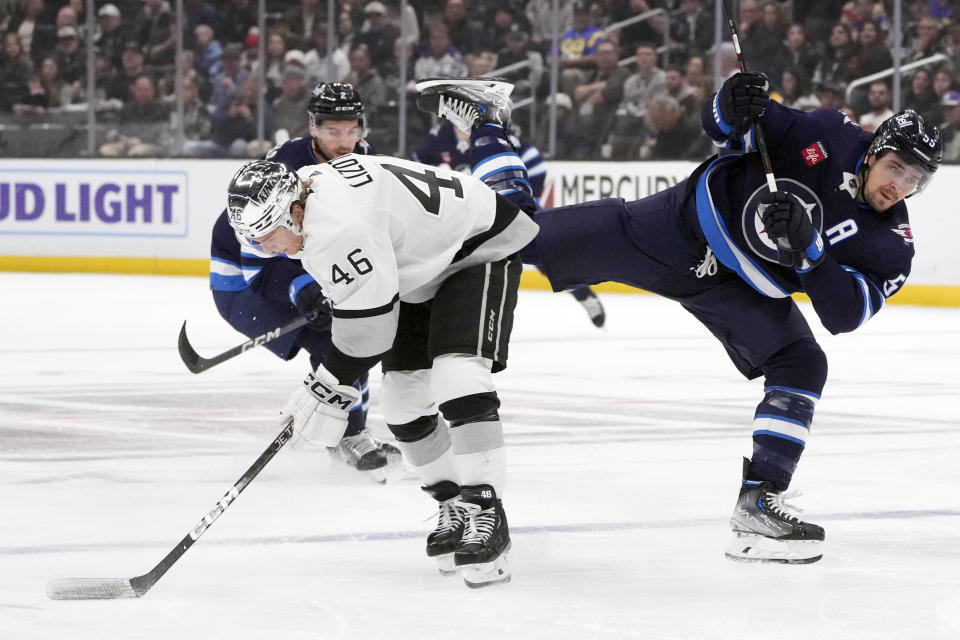 Winnipeg Jets center Mark Scheifele, right, collides with Los Angeles Kings center Blake Lizotte during the first period of an NHL hockey game Saturday, March 25, 2023, in Los Angeles. (AP Photo/Marcio Jose Sanchez)