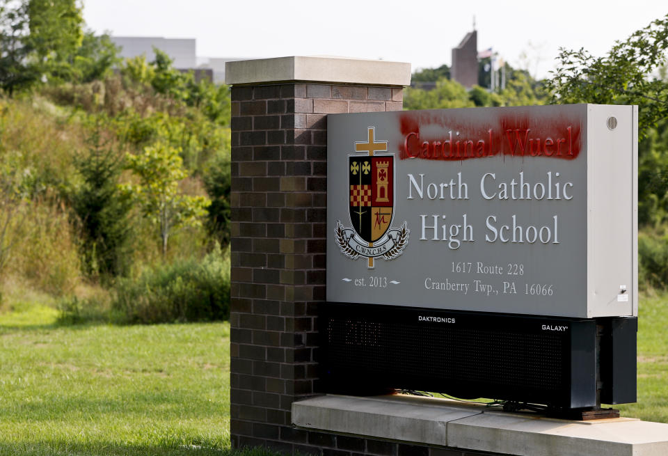 Paint covers the name of Cardinal Wuerl at Cardinal Wuerl North Catholic High School, on Monday, Aug. 20, 2018, in Cranberry Township, Pa. Wuerl, a Roman Catholic Cardinal, and the archbishop of Washington, D.C., has come under fire from revelations in the Pennsylvania grand jury report about his actions while bishop of Pittsburgh. (AP Photo/Keith Srakocic)