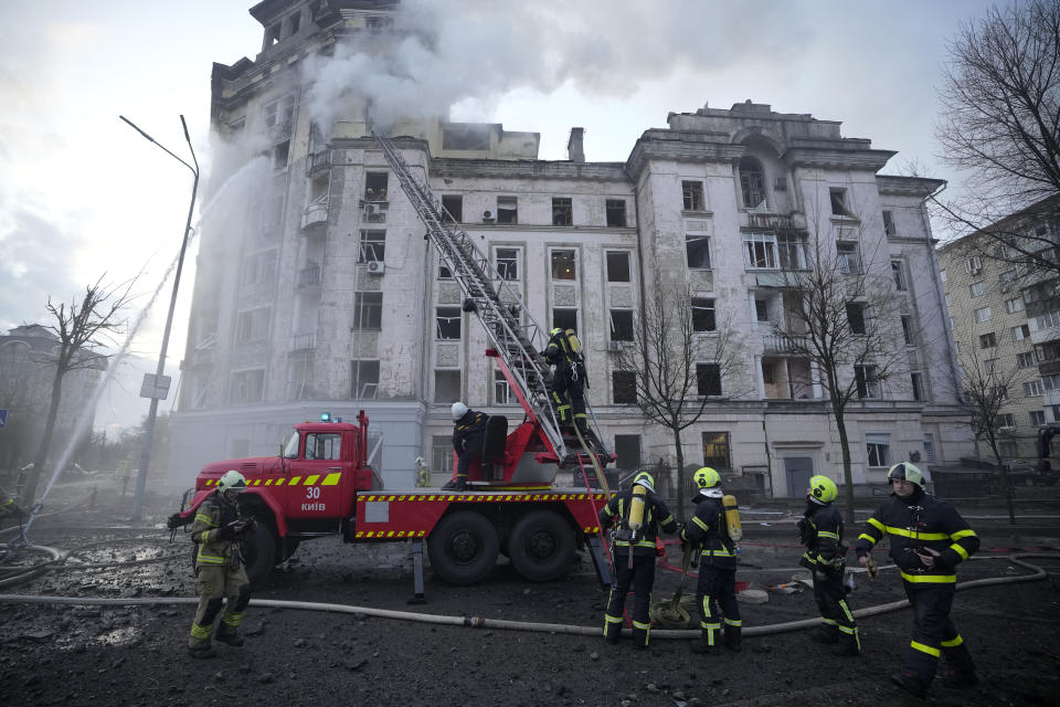 Firefighters work at the site after Russian attacks in Kyiv, Ukraine, Thursday, March 21, 2024. Around 30 cruise and ballistic missiles were shot down over Kyiv on Thursday morning, said Serhii Popko, the head of Kyiv City Administration. The missiles were entering Kyiv simultaneously from various directions in a first missile attack on the capital in 44 days. (AP Photo/Vadim Ghirda)