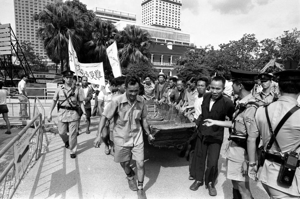 A group of boat dwellers presented a sampan to the Public Works Department as they urged the Chinese government to rehouse them.