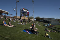 Socially distanced fans watch a spring baseball game between the Arizona Diamondbacks and the Milwaukee Brewers in Scottsdale, Ariz., Monday, March 1, 2021. (AP Photo/Jae C. Hong)