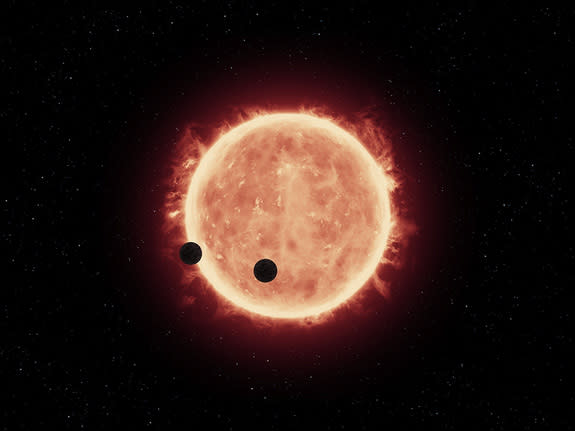 Artist's illustration of two Earth-size exoplanets crossing the face of the dim star TRAPPIST-1, which lies just 39 light-years from Earth.
