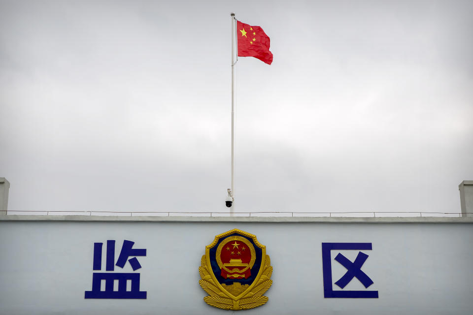 A Chinese national flag flies over a vehicle entrance to the inmate detention area at the Urumqi No. 3 Detention Center in Dabancheng in western China's Xinjiang Uyghur Autonomous Region, on April 23, 2021. (AP Photo/Mark Schiefelbein)
