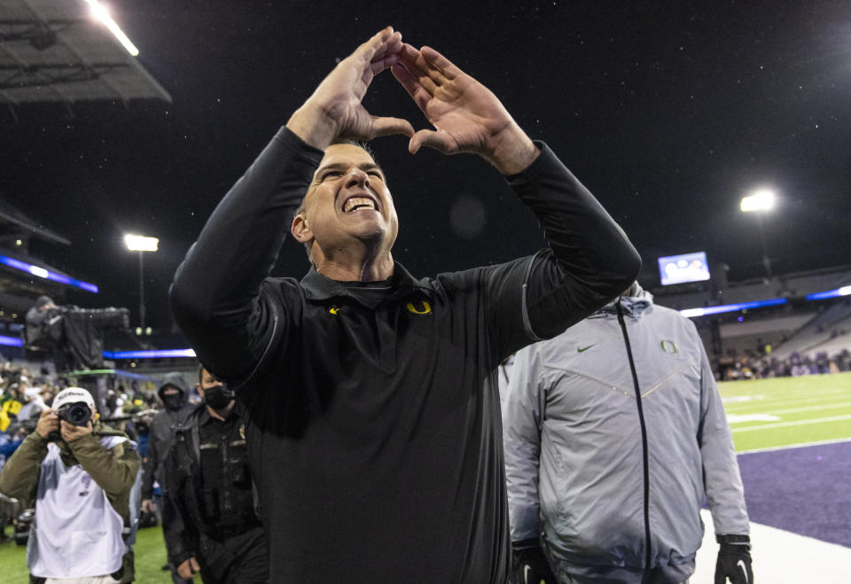 Oregon head coach Mario Cristobal celebrates after an NCAA college football game against Washington, Saturday, Nov. 6, 2021, in Seattle. (AP Photo/Stephen Brashear)