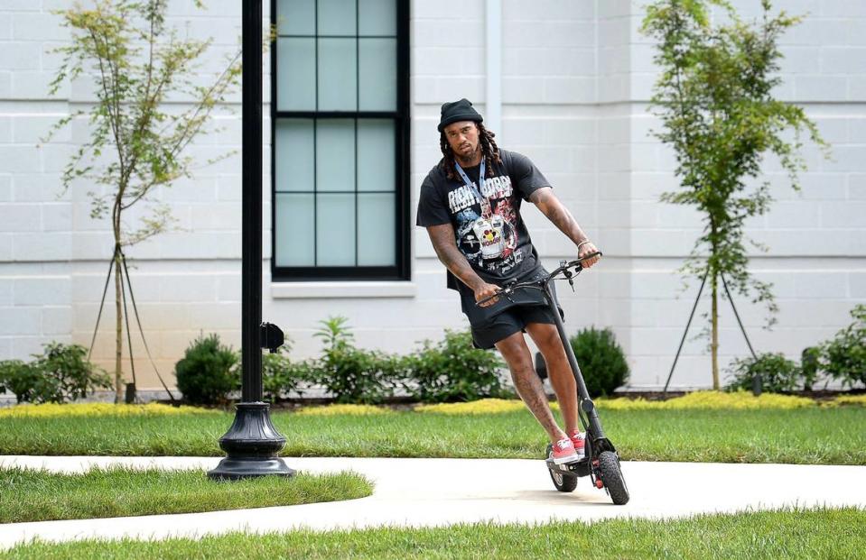 Carolina Panthers linebacker Shaq Thompson rides a scooter outside the team’s dormitory at Wofford College in Spartanburg Tuesday. Thompson said with all the young players on defense that, at age 27, he felt like a “2015 Honda.”