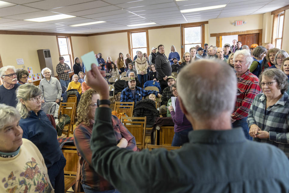 Bruce Olson gives instructions on how to vote to residents attending the annual Town Meeting, Tuesday, March 5, 2024, in Elmore, Vt. Democracy takes many forms, and some are more direct than others. In Elmore, the tradition of Town Meeting is very direct and the business of running a town and participating in its administration was thrown open to everyone for the yearly meeting today. The nuts and bolts of town business and decision-making get done, and in the process something unfolds that doesn't happen everywhere in the republic these days — in-person politics that are civil, friendly and followed by lunch. (AP Photo/David Goldman)