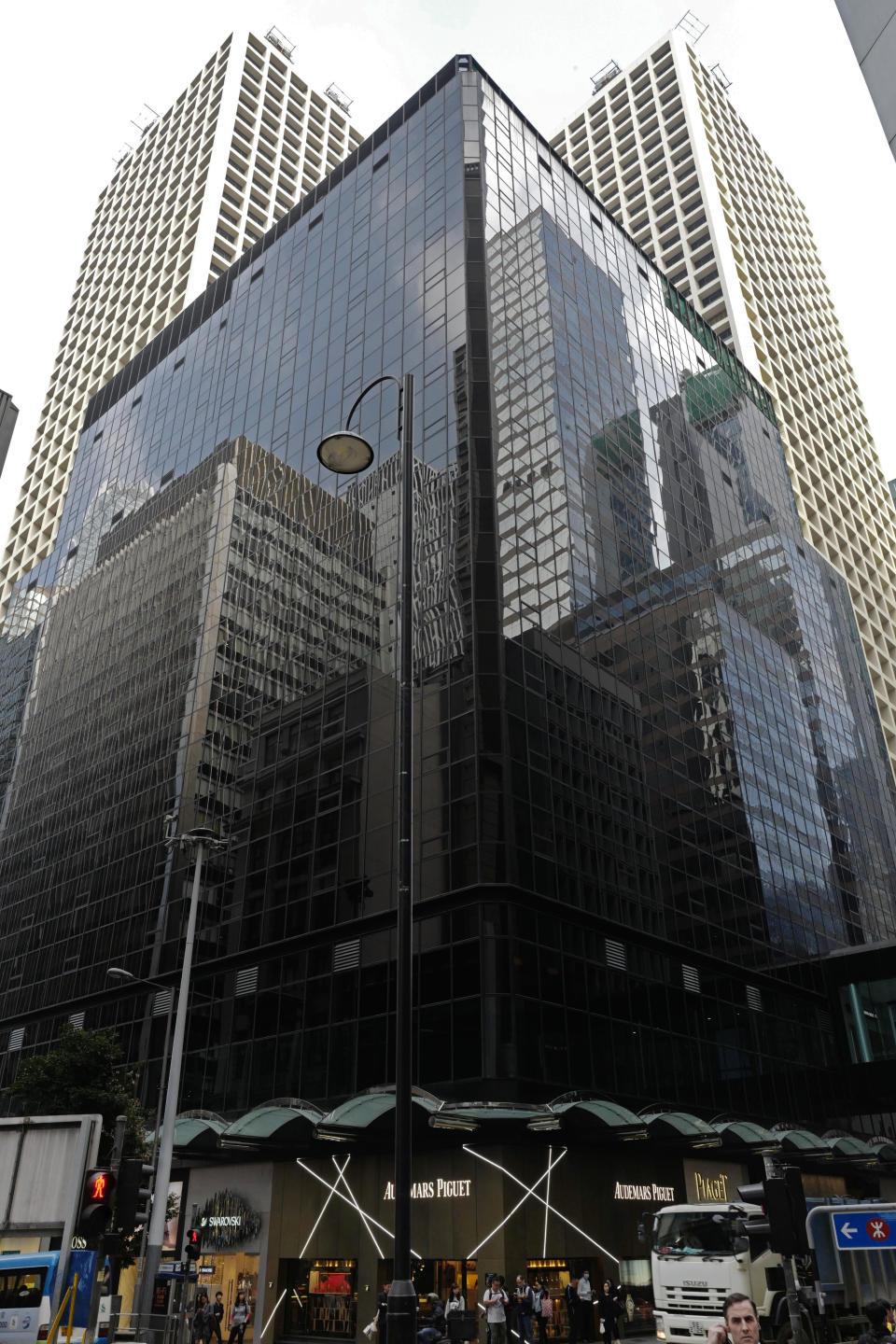 This Monday, Feb. 4, 2019 photo shows the exterior of the address 3 Pedder St., Central in Hong Kong. The building was supposedly the home of ENE Investments, but an Associated Press investigation has found that the firm is little more than a front for an elaborate undercover operation targeting security researchers, lawyers and a journalist. (AP Photo/Vincent Vu)