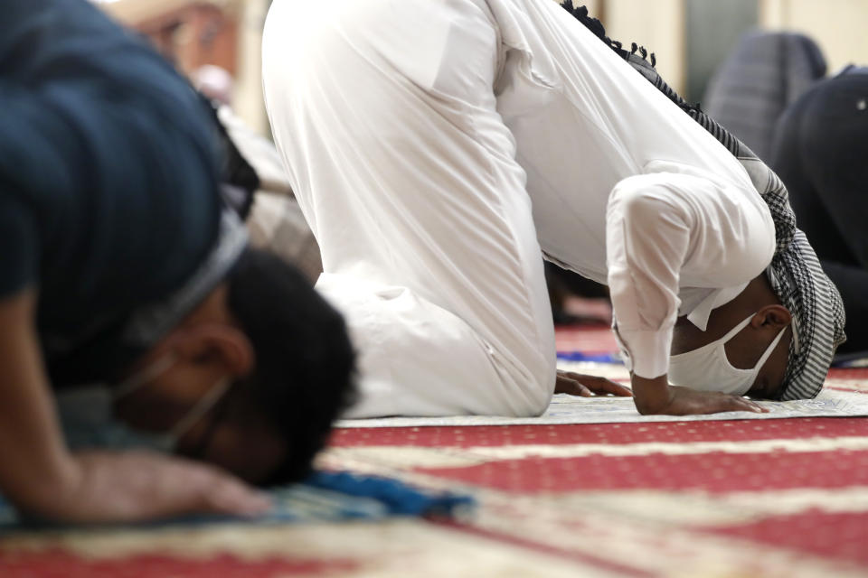 A Muslim bows in Sijdah during an evening prayer called "tarawih" marking the first eve of the holy fasting month of Ramadan at Chicago's Muslim Community Center on Monday, April 12, 2021. (AP Photo/Shafkat Anowar)