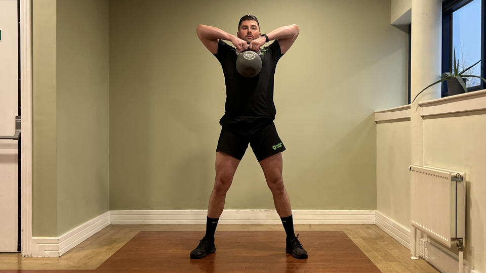 Sam Quinn, strength coach at Nuffield Health, demonstrates a sumo lift