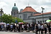 Members of the public queue to pay their respects to Singapore's late former prime minister Lee Kuan Yew, outside Parliament House, on March 25, 2015