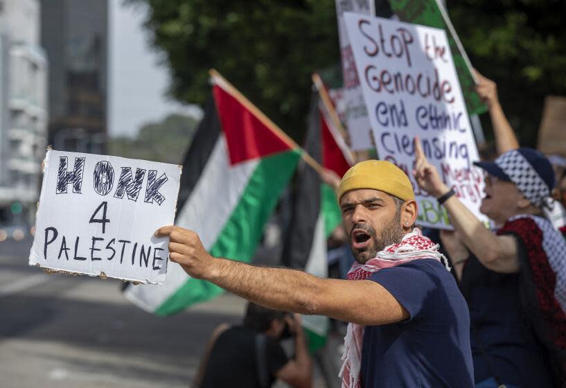 LOS ANGELES, CA-NOVEMBER 4, 2023, 2023:Ameen Bedouin, 34, left, joins other protesters, demanding an end to the Israeli invasion of Gaza during a pro-Palestinian rally outside the Israeli Consulate on Wilshire Blvd. in Los Angeles. (Mel Melcon / Los Angeles Times)