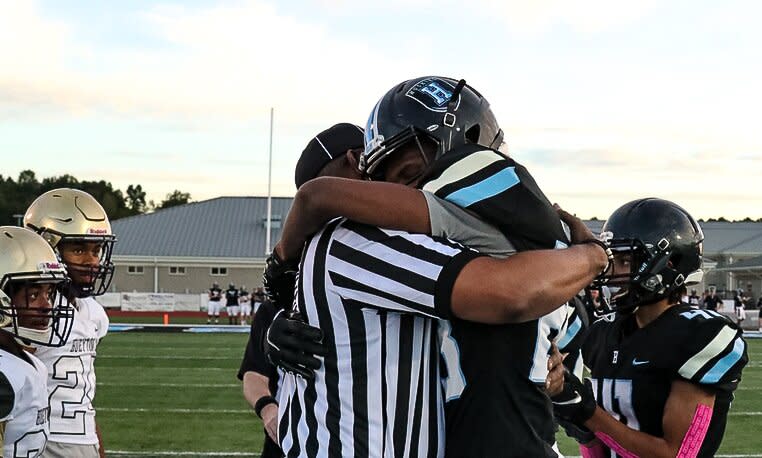 football player hugs dad dressed as referee