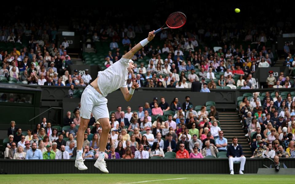 John Isner of United States of America serves against Andy Murray of Great Britain during their Men's Singles Second Round match on day three of The Championships - Shaun Botterill/Getty Images