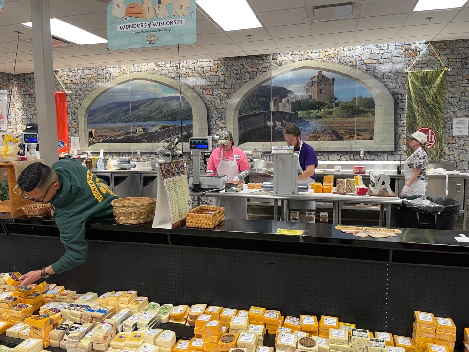 workers in the cheese section of the mars cheese castle in wisconsin