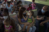 Parents wait to have their children vaccinated with the Soberana-02 COVID-19 vaccine, at a clinic in Havana, Cuba, Thursday, Sept. 16, 2021. Cuba began inoculating children as young as 2-years-old with locally developed vaccines on Thursday. (AP Photo/Ramon Espinosa)