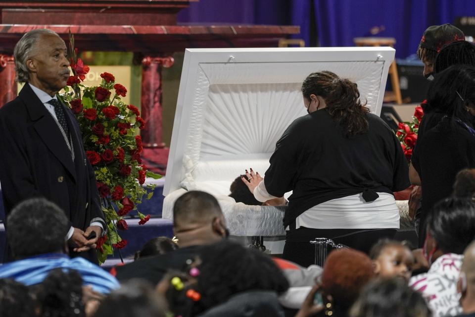 Katie Wright, mother of Daunte Wright, places her hand on her son during visitation, Wednesday, April 21, 2021, in Minneapolis. Daunte Wright was fatally shot by a police officer during a traffic stop. (AP Photo/Morry Gash)