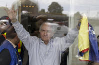 En esta imagen de archivo, tomada el 17 de noviembre de 2017, el derrocado alcalde de Caracas Antonio Ledezma, con una bandera de Venezuela en la mano, saluda desde el interior del aeropuerto internacional de El Dorado, en Bogotá, Colombia. (AP Foto/Ricardo Mazalán, archivo)