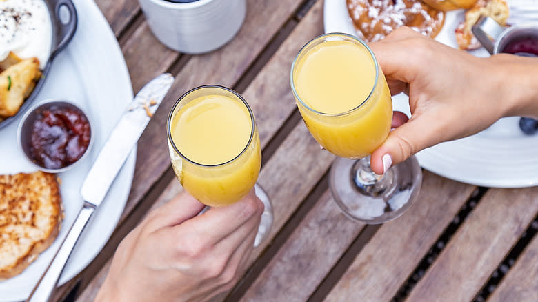 Two mimosas held over brunch