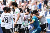 <p>The oldest keeper to ever play in the World Cup is smothered by his team-mates after his heroics </p>