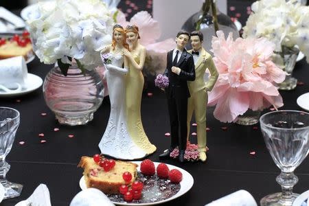 Same-sex couple plastic figurines are displayed during a gay wedding fair (salon du mariage gay) in Paris April 27, 2013. REUTERS/Gonzalo Fuentes