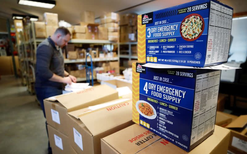 An employee double checks a customers order for a personal protection and survival equipment kit preparing against novel coronavirus, at Nitro-Pak in Midway