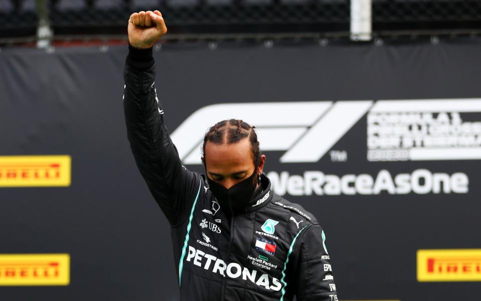 Lewis Hamilton of Great Britain and Mercedes GP raises his fist as he stands on the podium in a stand against racism after the Formula One Grand Prix of Styria at Red Bull Ring on July 12, 2020 in Spielberg, Austria - GETTY IMAGES