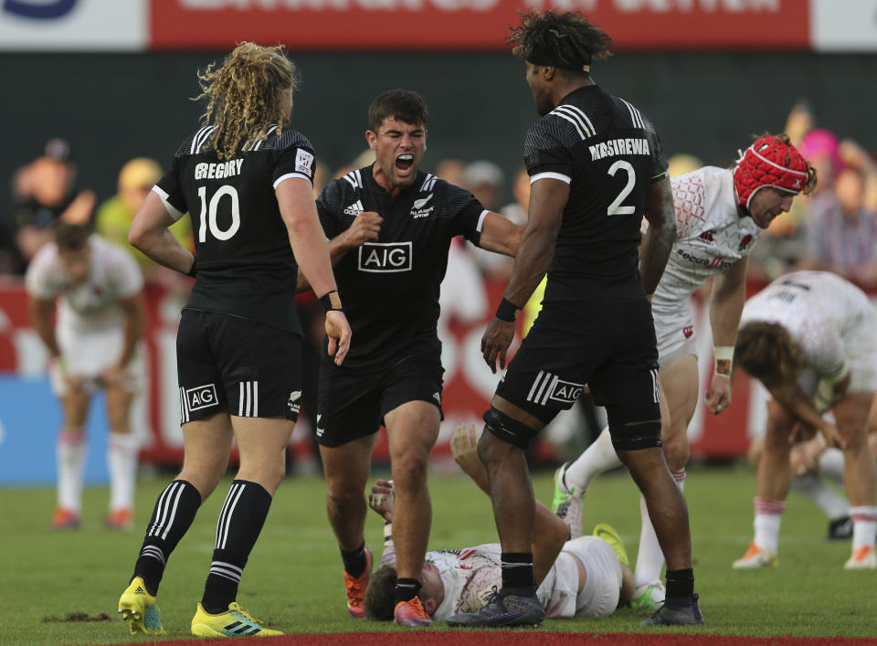 New Zealand's players celebrate after they defeated England in a semi final match of the Emirates Airline Rugby Sevens in Dubai, the United Arab Emirates, Saturday, Dec. 1, 2018. (AP Photo/Kamran Jebreili)